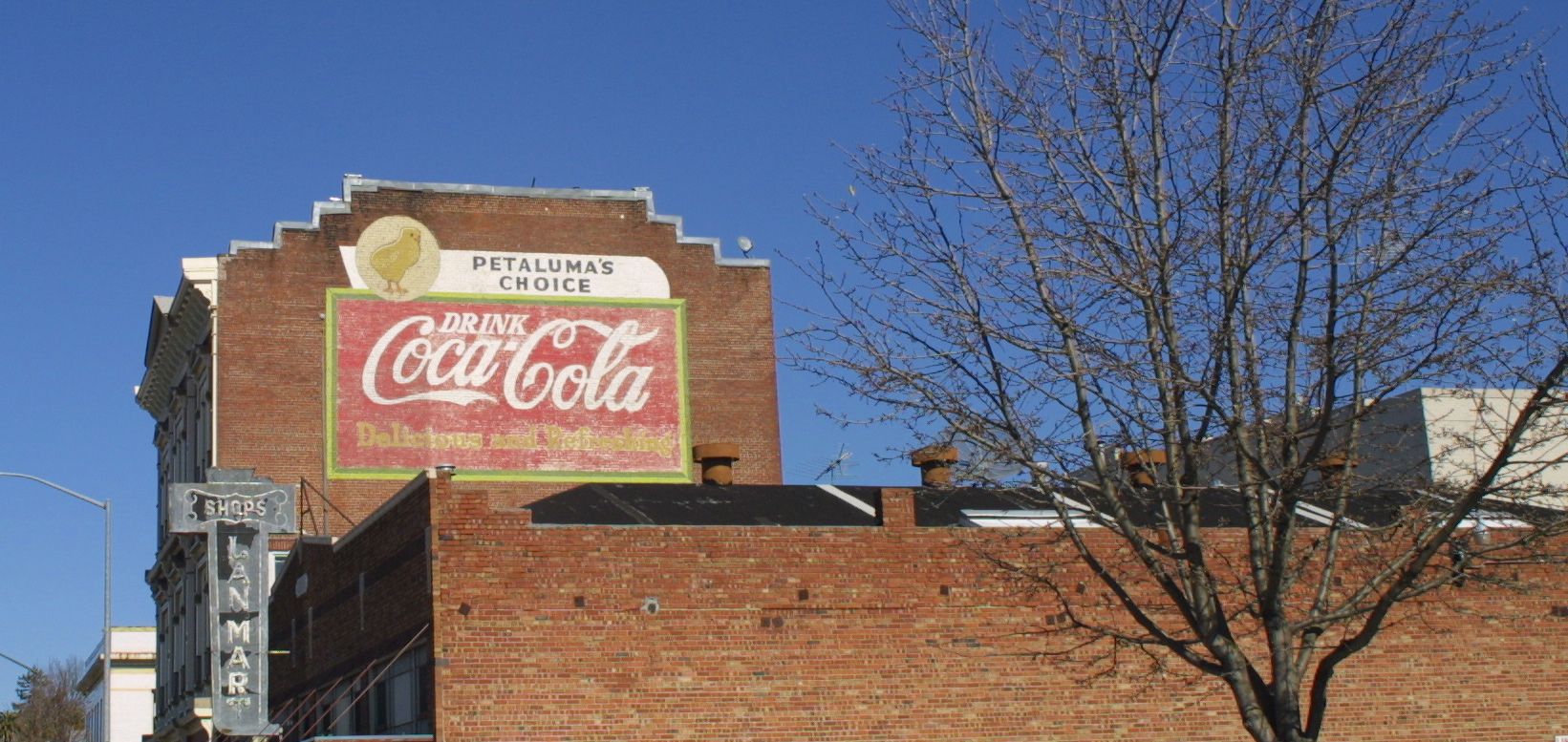 Photo of vintage Coca-Cola sign on building